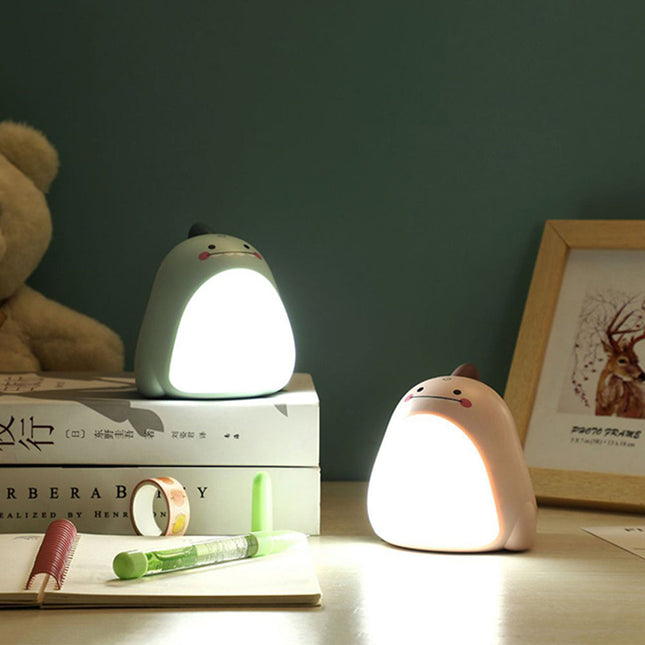 Grøn dinosaur natlampe med lysende mave