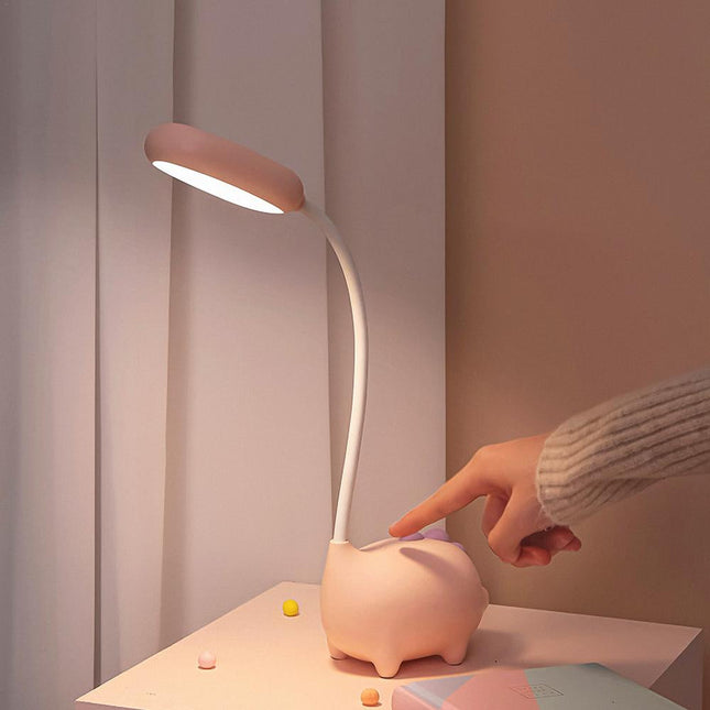 Lyserød skrivebordslampe formet som gris