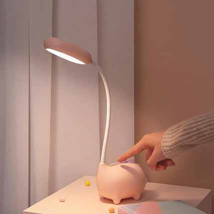 Lyserød skrivebordslampe formet som gris