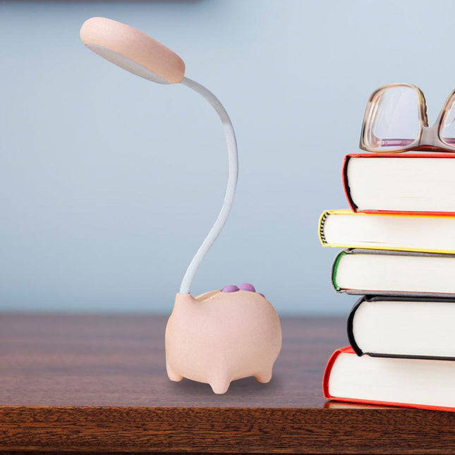 Lyserød skrivebordslampe formet som gris